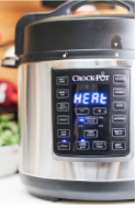 An electronic pressure cooker heating it's contents.